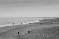 Bamburgh Beach with people enjoying the day