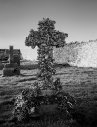 Eroded cross gravestone