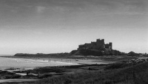 Bamburgh Castle And Beach in black and white